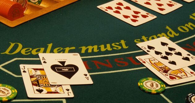 blackjack table with cards and chips on it